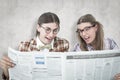 A Composite image of geeky hipsters reading the newspaper Royalty Free Stock Photo