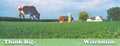 Composite image of a giant cow grazing behind a distant farm with a silo and barn