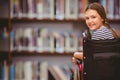 Composite image of girl sitting in wheelchair in school Royalty Free Stock Photo