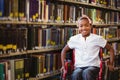 Composite image of girl sitting in wheelchair in school corridor Royalty Free Stock Photo