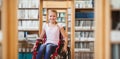 Composite image of girl sitting in wheelchair in school corridor Royalty Free Stock Photo