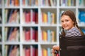 Composite image of girl sitting in wheelchair in school Royalty Free Stock Photo