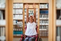 Composite image of girl in wheelchair in school corridor Royalty Free Stock Photo