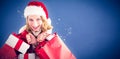 Composite image of girl in winter fashion holding presents and shopping bags Royalty Free Stock Photo