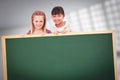 Composite image of girls behind a blank panel Royalty Free Stock Photo