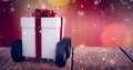 Composite image of gray gift box with wheels Royalty Free Stock Photo