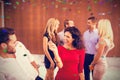Composite image of group of cheerful young friends dancing Royalty Free Stock Photo