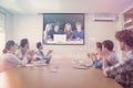 Composite image of a group of students with a laptop look into the camera Royalty Free Stock Photo