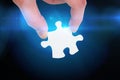 Composite image of hand holding jigsaw piece Royalty Free Stock Photo