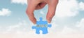 Composite image of hand holding jigsaw piece Royalty Free Stock Photo