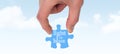 Composite image of hand holding jigsaw piece Royalty Free Stock Photo