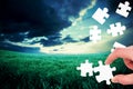 Composite image of hand holding jigsaw piece Royalty Free Stock Photo