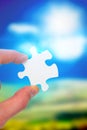 Composite image of hand holding jigsaw piece Royalty Free Stock Photo