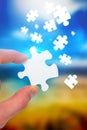 Composite image of hand holding jigsaw piece Royalty Free Stock Photo