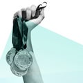 Composite image of hand holding three medals on white background Royalty Free Stock Photo