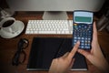 Composite image of hands of businesswoman using calculator Royalty Free Stock Photo