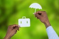 Composite image of hands holding a schoolbag and an umbrella in paper Royalty Free Stock Photo