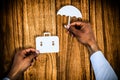 Composite image of hands holding a schoolbag and an umbrella in paper Royalty Free Stock Photo