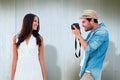 Composite image of handsome hipster taking a photo of pretty girlfriend Royalty Free Stock Photo