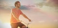 Composite image of handsome man on a bike ride on a sunny day Royalty Free Stock Photo