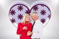 Composite image of handsome man giving his wife a pink rose Royalty Free Stock Photo