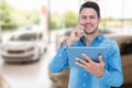 Composite image of handsome man holding digital tablet while talking on mobile phone Royalty Free Stock Photo