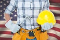 Composite image of handyman holding hammer and hard hat Royalty Free Stock Photo