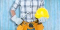 Composite image of handyman holding hammer and hard hat Royalty Free Stock Photo