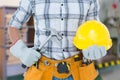 Composite image of handyman holding hammer and hard hat Royalty Free Stock Photo