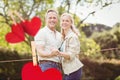 Composite image of hanging red hearts and couple embracing each other Royalty Free Stock Photo