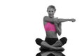 Composite image of happy blonde sitting in lotus pose stretching arms