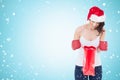 Composite image of happy brunette in boxing gloves looking in shopping bag Royalty Free Stock Photo