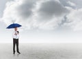 Composite image of happy businessman holding umbrella Royalty Free Stock Photo