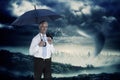 Composite image of happy businessman holding umbrella Royalty Free Stock Photo