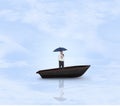 Composite image of happy businessman holding umbrella in a sailboat Royalty Free Stock Photo