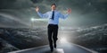 Composite image of happy businessman running with hands up Royalty Free Stock Photo