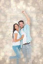 Composite image of happy casual couple cheering at camera Royalty Free Stock Photo