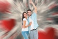 Composite image of happy casual couple cheering at camera Royalty Free Stock Photo