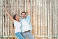Composite image of happy casual couple cheering together Royalty Free Stock Photo