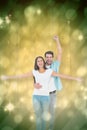 Composite image of happy casual couple cheering together Royalty Free Stock Photo