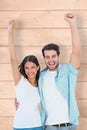 Composite image of happy casual couple cheering together Royalty Free Stock Photo