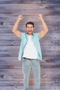 Composite image of happy casual man cheering at camera Royalty Free Stock Photo