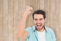 Composite image of happy casual man cheering at camera Royalty Free Stock Photo