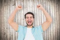 Composite image of happy casual man cheering at camera Royalty Free Stock Photo