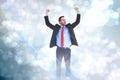 Composite image of happy cheering businessman raising his arms Royalty Free Stock Photo