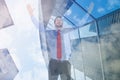 Composite image of happy cheering businessman raising his arms Royalty Free Stock Photo