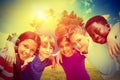 Composite image of happy children forming huddle at park