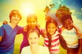 Composite image of happy children forming huddle at park