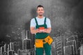 Composite image of happy construction worker holding house model Royalty Free Stock Photo
