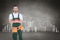 Composite image of happy construction worker holding house model Royalty Free Stock Photo